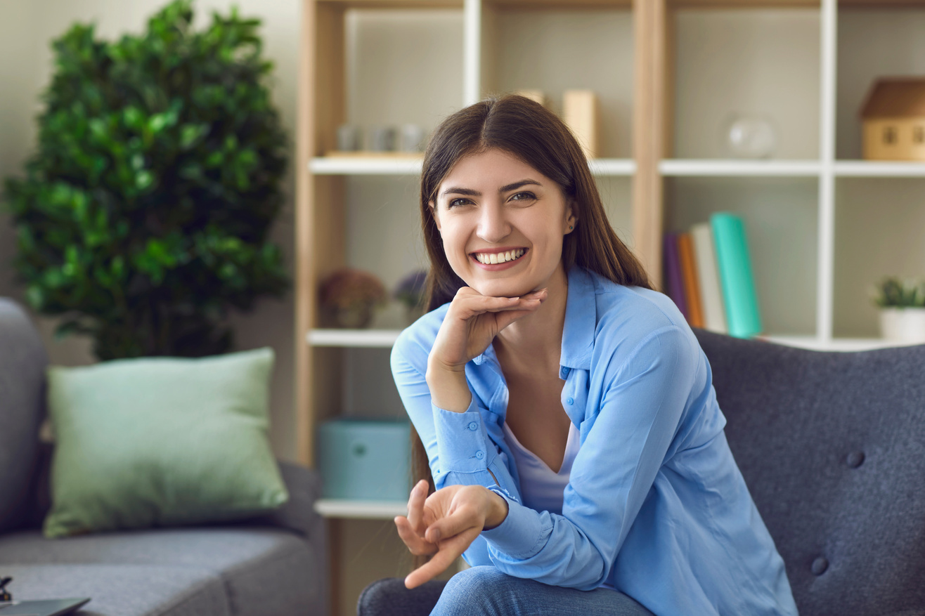 Happy Girl Looking at Camera and Communicating Online from Home. Businesswoman on Web Conference